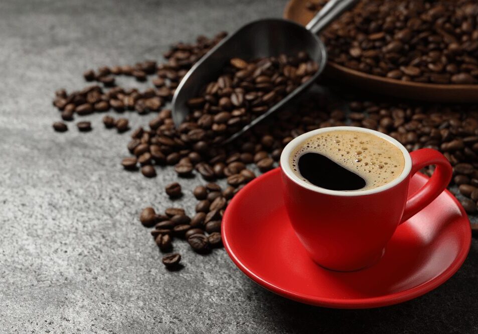 Coffee cup with beans on table.